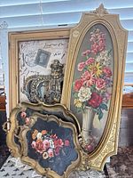 Group shot showing all four pieces: oval floral print, crown shadow box, two Florentine trays