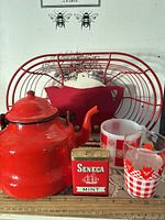 Group shot of all items: kettle, basket, tin, glassware, ruler