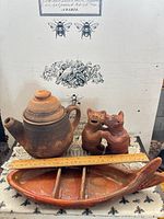 Lot overview showing teapot, cat figurine, fish dish with ruler for scale