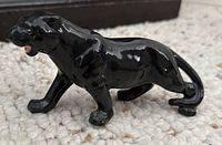 Smaller crouching black ceramic panther figurine, side view