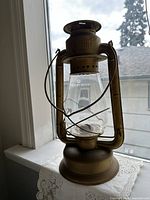 Full view of Beacon kerosene lantern showing body, globe, handle and base