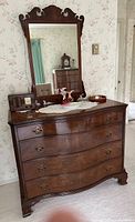 Front view showing dresser, drawers, hardware, mirror frame