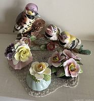 Group shot showing bird figurine and three floral bouquets
