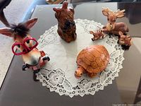 Group view of all six figurines on glass table