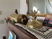 Close-up of brass piano lamp on surface