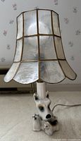 Full view of porcelain Scottie dog lamp with capiz shell shade attached