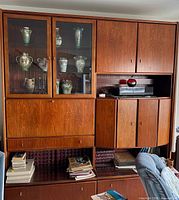 Full view of wall unit showing glass display, cabinets, drawers