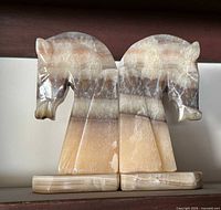 Frontal view of both onyx horse head bookends showing color and condition
