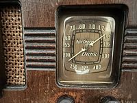 Close-up of dial showing Northern Electric branding and frequency scale