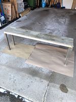 Full view of aluminum bench on garage floor