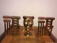Full lot showing brass mask and pair of bookends