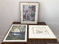 All three framed prints on table