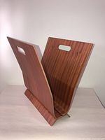Full view of V-shaped teak bentwood magazine rack showing handles and base