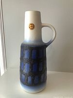 Front view of VEB Haldensleben ceramic vase showing label, handle and textured blue-black pattern