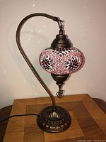 Full view of lamp on stand showing mosaic shade and base