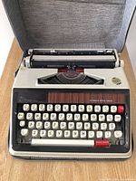 Top view of Brother Deluxe 1350 typewriter inside open case showing keyboard and layout