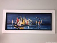 Overall view of framed sailboat regatta print on wall