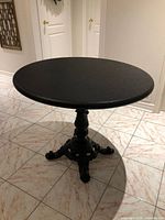 Full view of round table showing top and pedestal base
