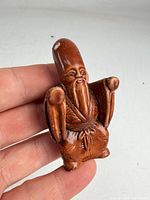 Front view showing elder figure with long beard and tall head