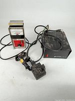 Astron power supply, Penske tachometer, Streamlight charger viewed together