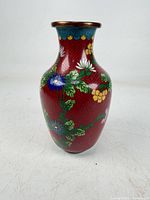 Full view of red Chinese cloisonné vase with floral pattern