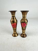 Front view of both brass vases showing floral motif