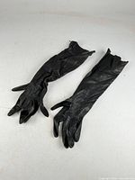 Full view of both black leather opera gloves