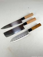 Three Japanese knives aligned to show blade types and handles