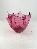 Oblique view showing overall shape, ruffled rim, color and foot