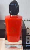 Front view of red Sì Passione bottle showing logo and cap