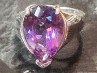 Front view of sterling silver ring showing pear-shaped purple amethyst stone
