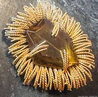 Front view showing amber glass center and rope-twist starburst design