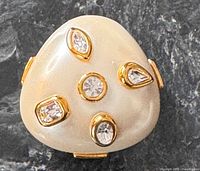 Front view showing faux pearl cabochon and rhinestones