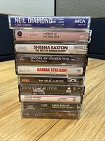 Front view of stacked cassette tapes showing album titles
