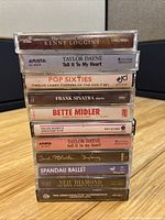 Front spine view showing all 11 cassette titles in stack
