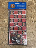 Front view of sealed Looney Tunes checkers set showing board pattern and pieces.