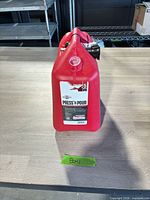 Front view of red Briggs & Stratton Press 'N Pour 5-gallon gas can