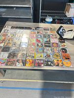 Wide view of table with rows of CD cases