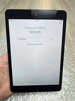 Front of iPad mini powered on to setup screen