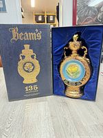 Decanter in fitted box next to outer sleeve