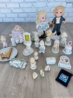 Full lot view showing dolls, figurines, ceramic pieces and accessories
