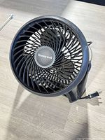 Front view of black Honeywell table fan showing grille and logo