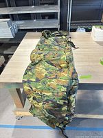 Full view of quilted camouflage blanket laid out on table