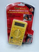 Front view of sealed package showing multimeter and battery