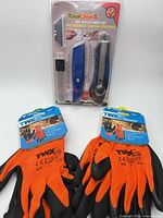 Full lot showing sealed knife set and two glove pairs