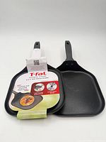 Two T-fal mini cheese griddles, one with packaging, one loose