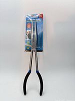 Full view of sealed 11" long nose pliers showing handles and packaging.