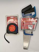 Front view of sealed tape measure and 2-piece saw set