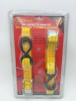Front view of sealed ToolDeal 2-pc buckle tie-down set packaging