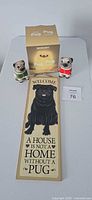 Overall lot showing LED light box, wooden pug sign, two ceramic pug figurines